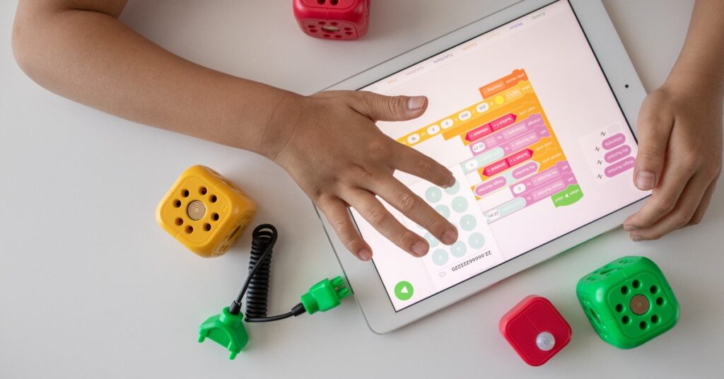 image of child's hands plying educational games on ipad