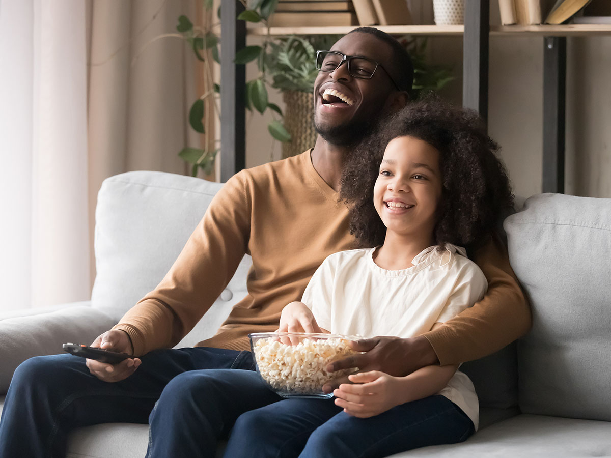 A parent and child watching a foreign movie.